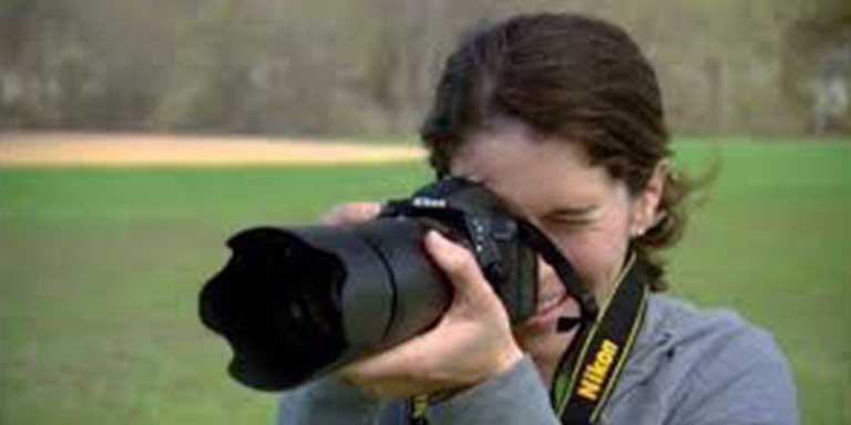woman pointing a camera forward to take a picture