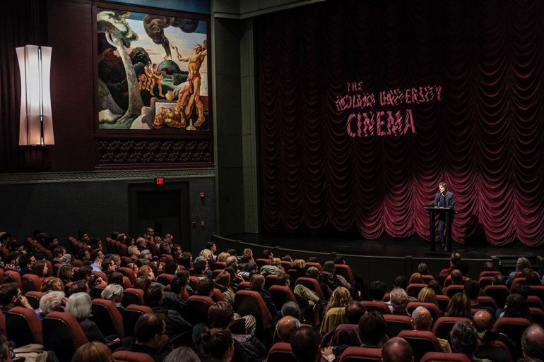 A full house at the IU Cinema watches as a man speaks from a podium on stage